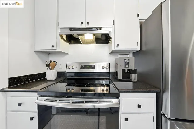 a bathroom with a granite countertop sink toilet a mirror and shower