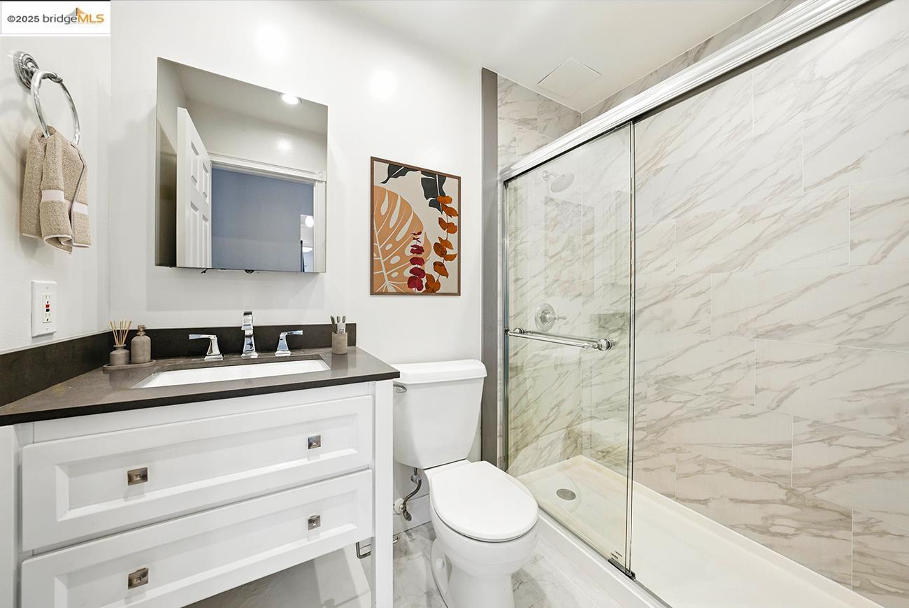 567 Oakland Avenue, Unit 101 Oakland, CA 94611 - Photo 8 of 50 Bathroom featuring vanity and a marble finish shower