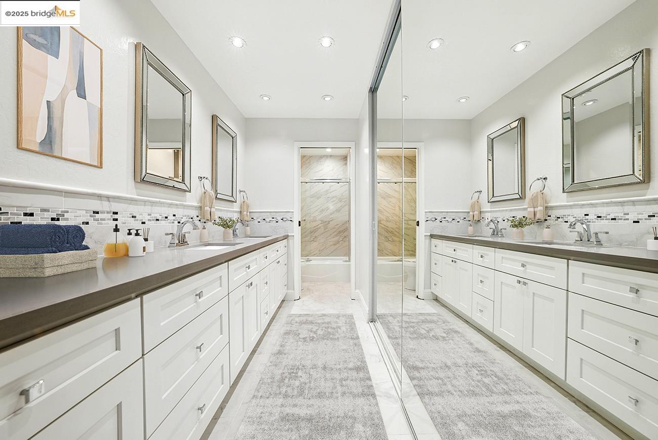 567 Oakland Avenue, Unit 101 Oakland, CA 94611 - Photo 10 of 50 Bathroom featuring double vanity, a shower stall, tasteful backsplash, recessed lighting, and a wainscoted wall