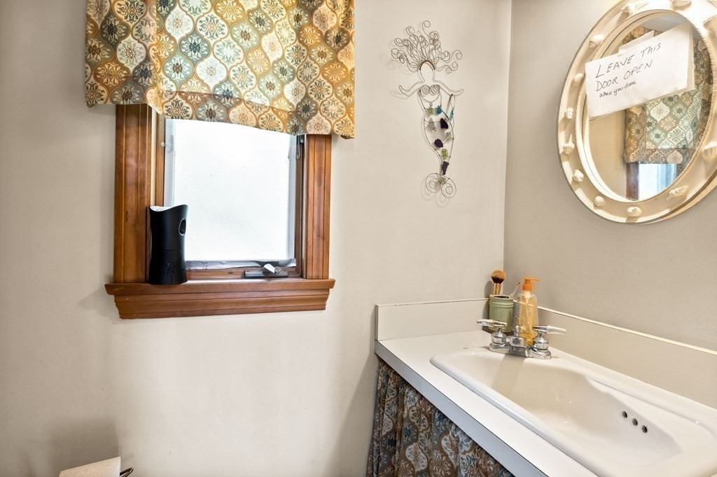 14 Tower Circle Bourne, MA 02532 - Photo 12 of 19 a bathroom with a sink a mirror and a window