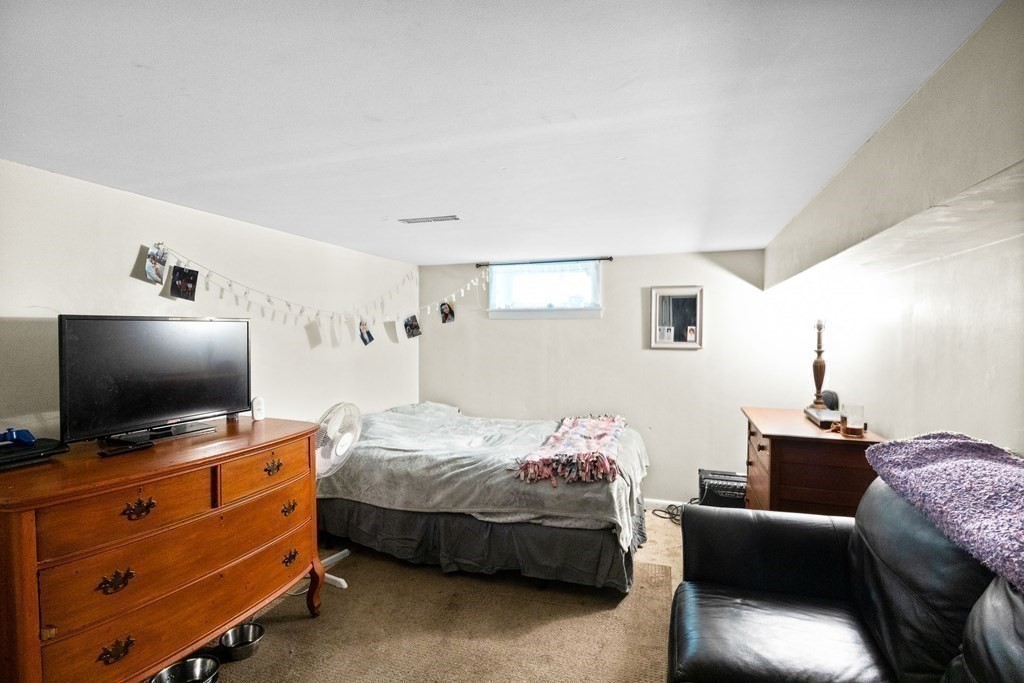 14 Tower Circle Bourne, MA 02532 - Photo 16 of 19 a bedroom with furniture and a flat screen tv