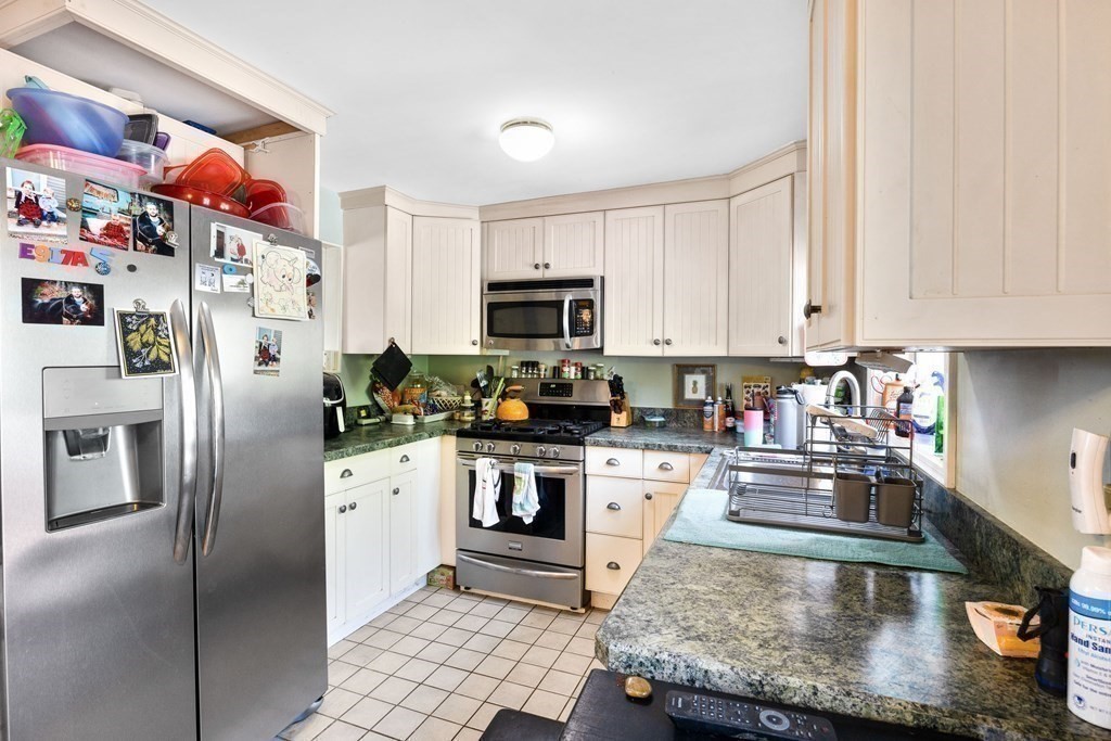 14 Tower Circle Bourne, MA 02532 - Photo 10 of 19 a kitchen with stainless steel appliances granite countertop a refrigerator sink and stove