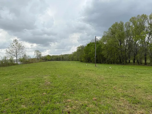 a view of a field with wooden fence