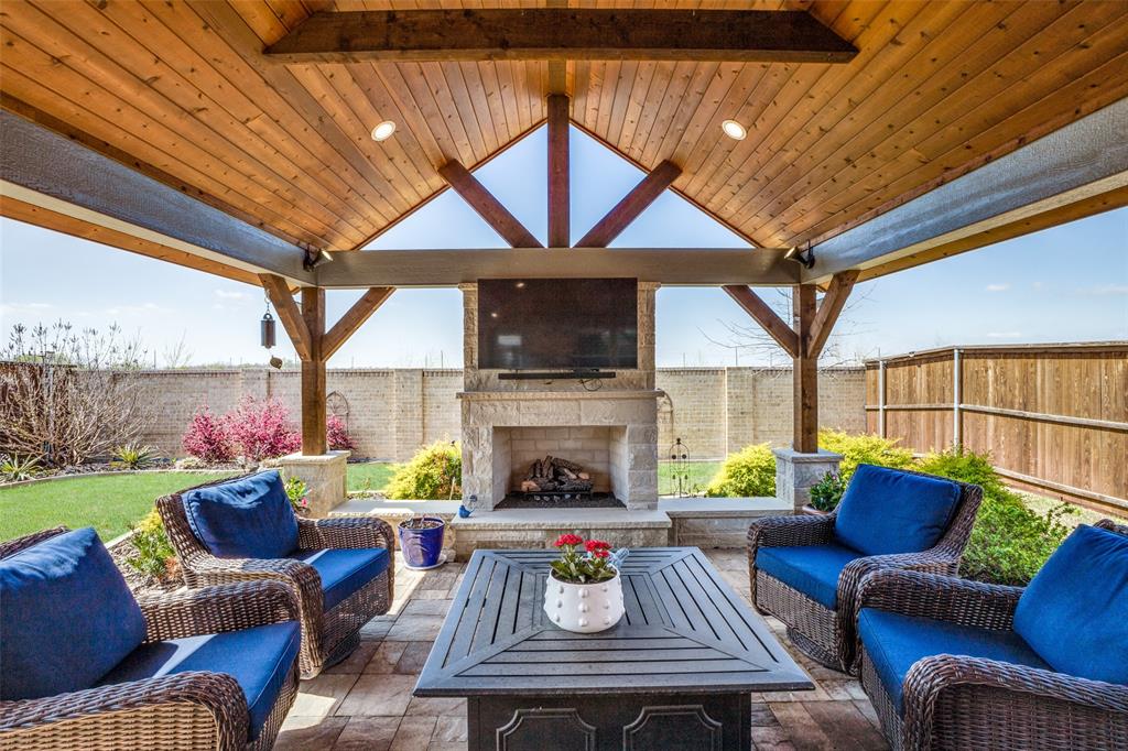 a outdoor space with patio furniture and a fireplace