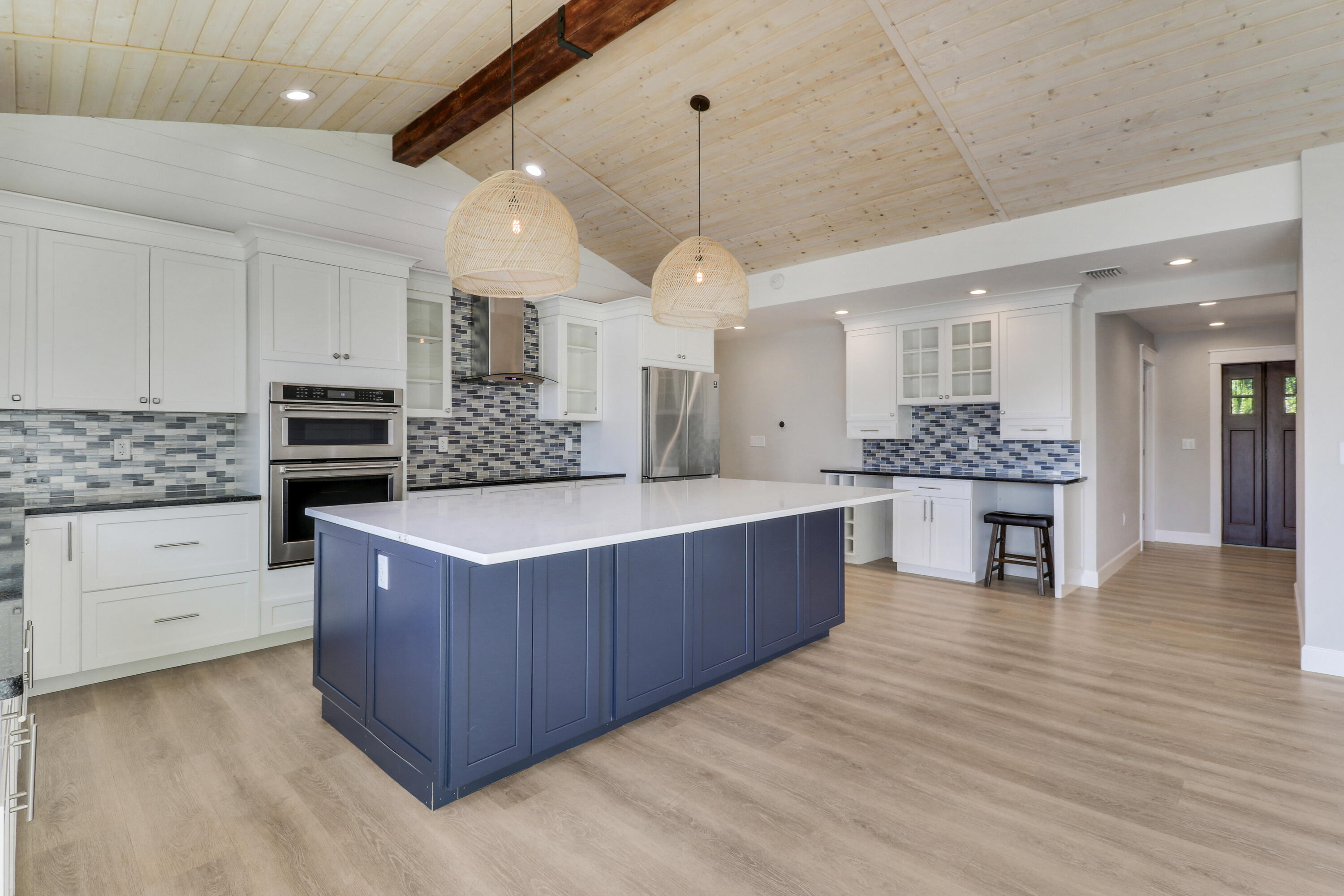 9195 Southeast Cove Point Street Jupiter, FL 33469 - Photo 18 of 80 a kitchen with stainless steel appliances granite countertop a large counter top a stove and a refrigerator
