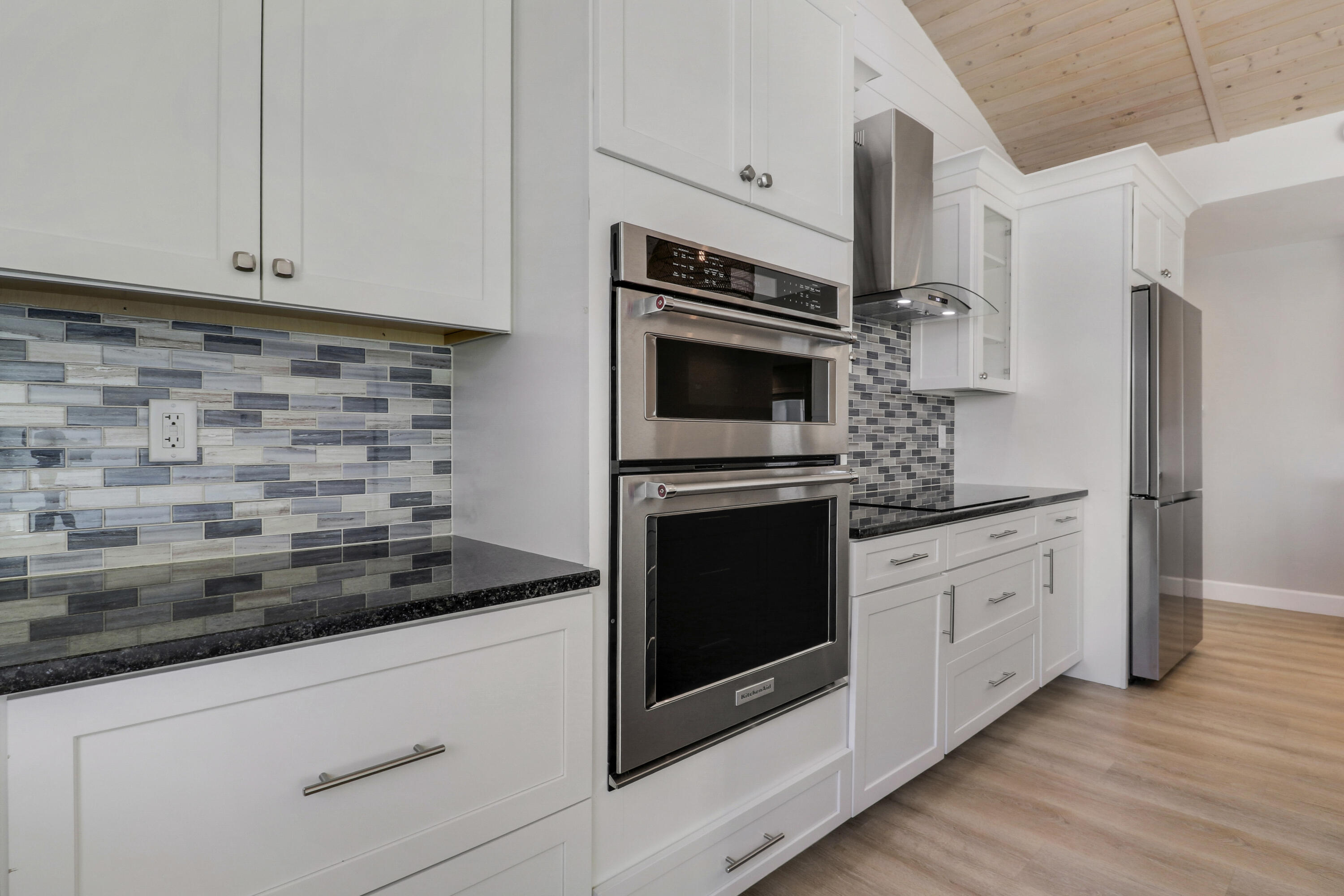 9195 Southeast Cove Point Street Jupiter, FL 33469 - Photo 28 of 80 a kitchen with stainless steel appliances white cabinets and a stove top oven