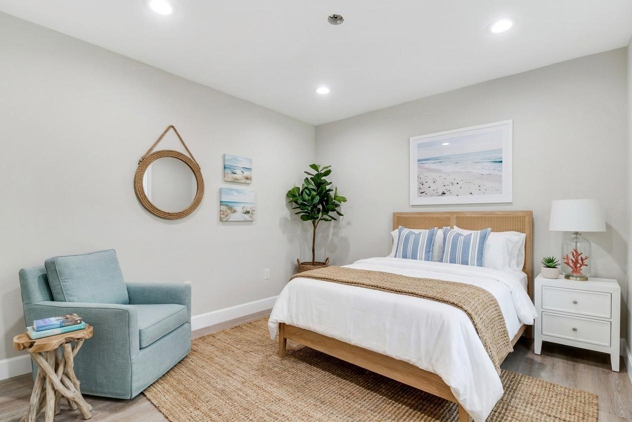 9195 Southeast Cove Point Street Jupiter, FL 33469 - Photo 38 of 80 a spacious bedroom with a bed and a couch