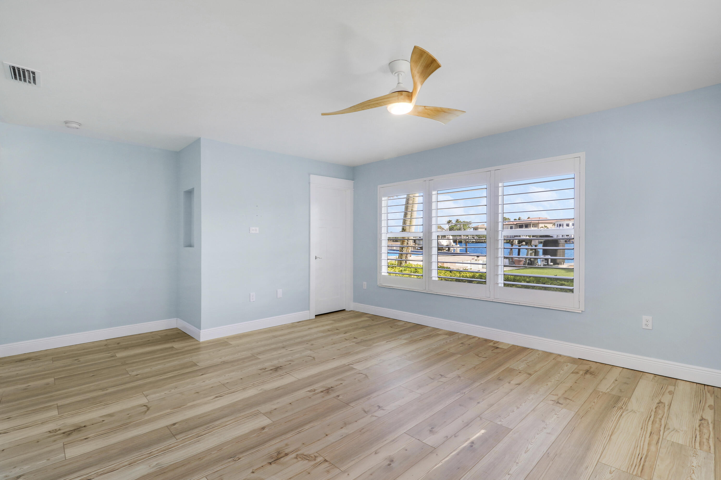 9195 Southeast Cove Point Street Jupiter, FL 33469 - Photo 45 of 80 a view of an empty room with a window and wooden floor