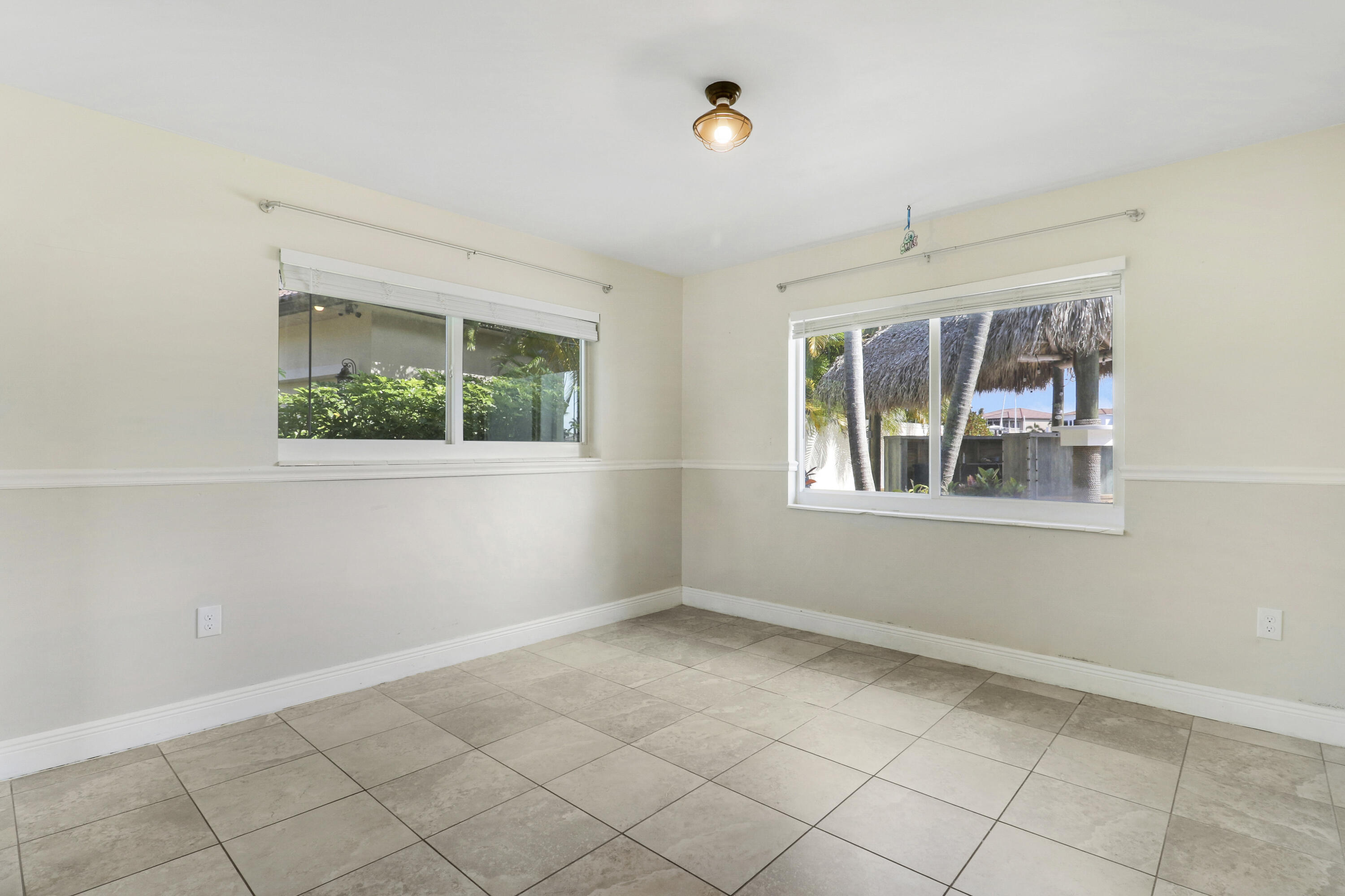 9195 Southeast Cove Point Street Jupiter, FL 33469 - Photo 49 of 80 an empty room with windows