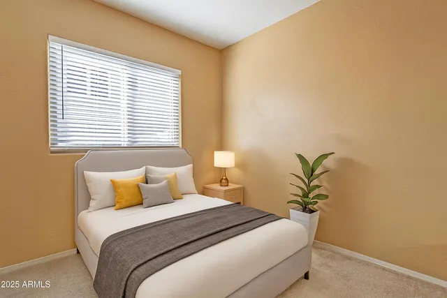 a bedroom with a bed and a window