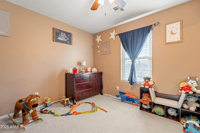 a living room with a chairs and a chandelier