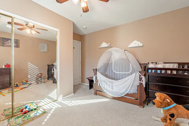 a bedroom with a bed a window and a chandelier