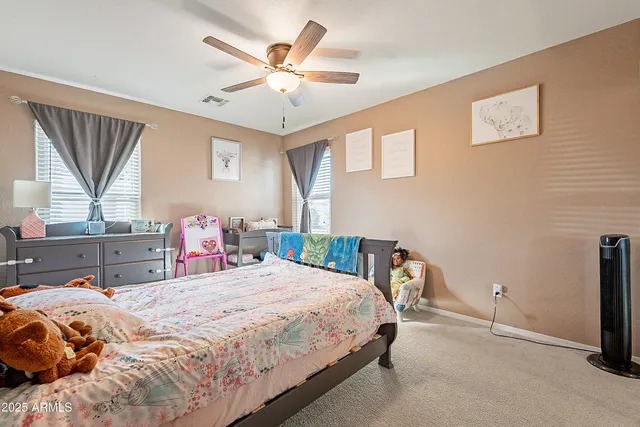 a bedroom with furniture and a large window