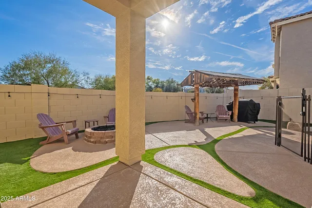 a view of a house with backyard and sitting area