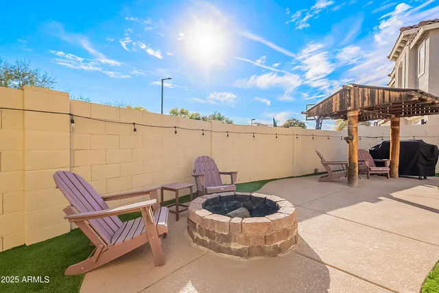 a view of a backyard with swimming pool