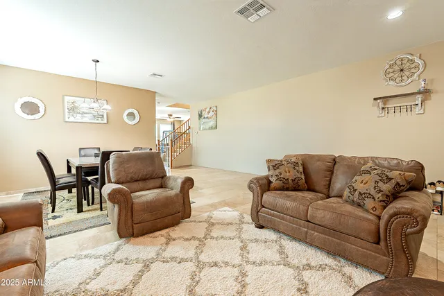 a living room with furniture lamp and window