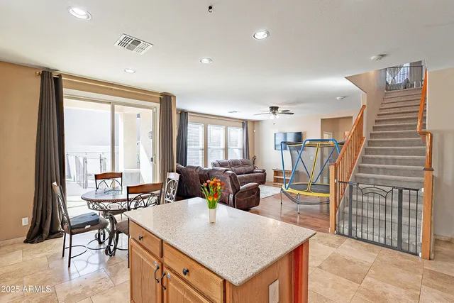a living room with furniture a flat screen tv and next to a window