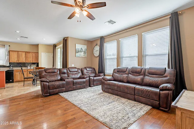 a living room with furniture wooden floor and window