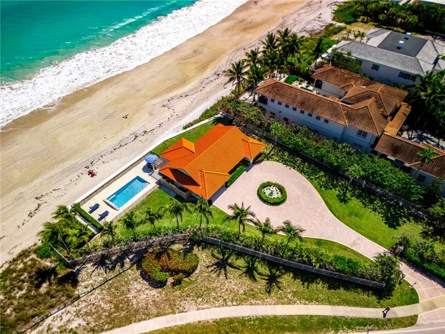 an aerial view of a house with a swimming pool