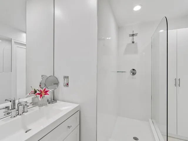 a bathroom with a sink vanity granite tub and shower