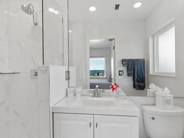 a bathroom with a sink vanity granite and a mirror