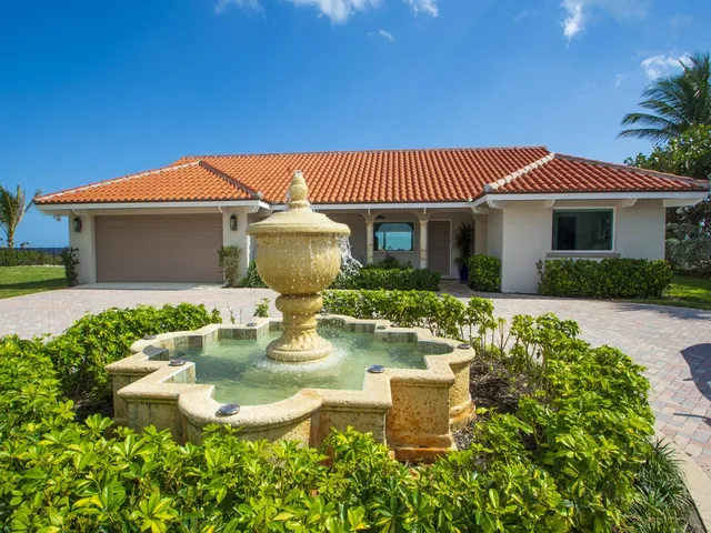 a front view of a house with garden and porch