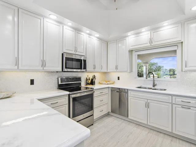 a kitchen with a sink stove and microwave