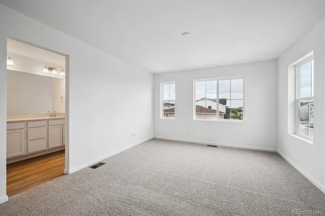 an empty room with windows and entrance