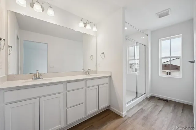 a bathroom with a double vanity sink and mirror