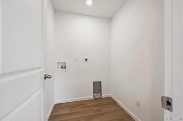 a view of a room with wooden floor