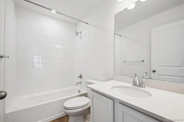 a bathroom with a sink toilet vanity and shower