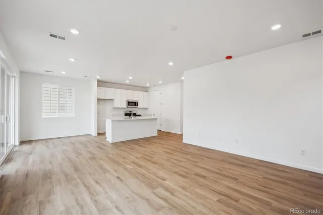 a view of kitchen with wooden floor and window