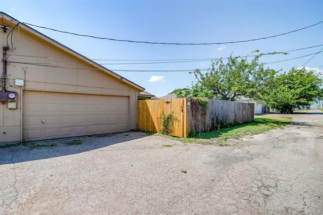 a view of a backyard with wooden fence