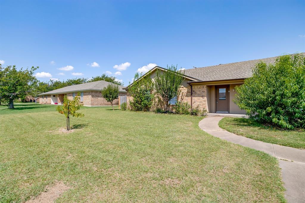 1203 North Nolan River Road, Unit A Cleburne, TX 76033 - Photo 3 of 20 a front view of a house with a yard