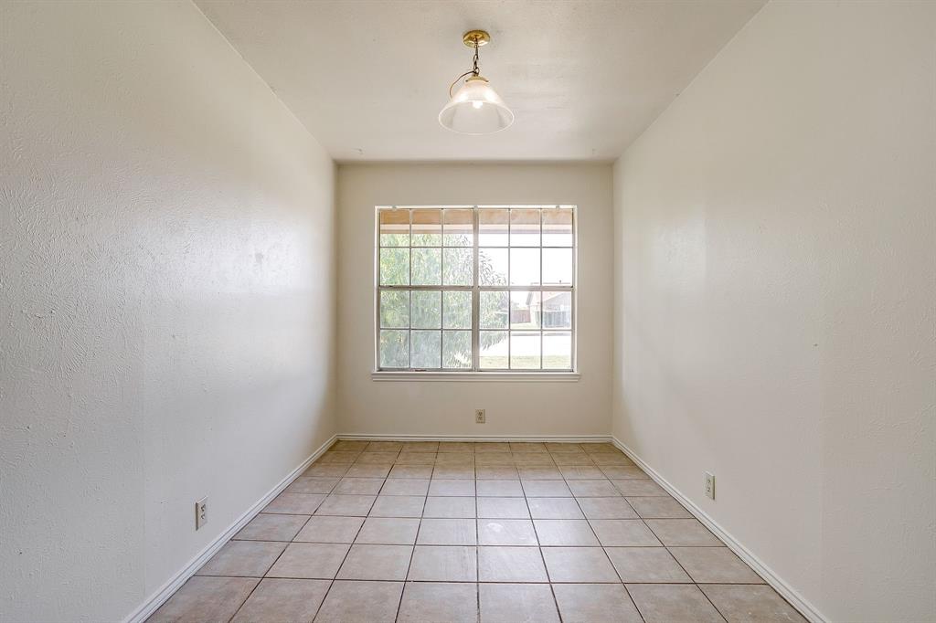 1203 North Nolan River Road, Unit A Cleburne, TX 76033 - Photo 5 of 20 an empty room with windows and fan