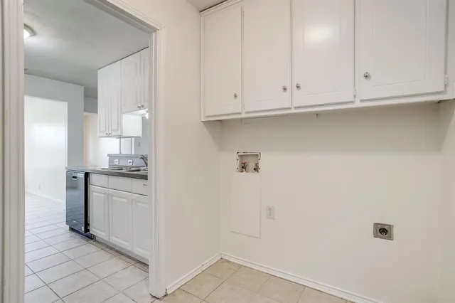 a kitchen with granite countertop white cabinets and stainless steel appliances