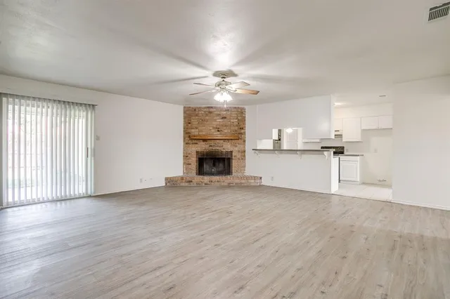 a view of a kitchen with a sink and a fireplace