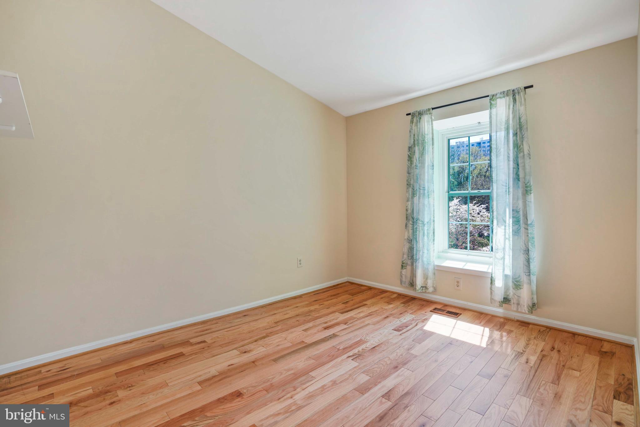 11322 Baritone Court Silver Spring, MD 20901 - Photo 15 of 29 a view of an empty room with wooden floor and a window