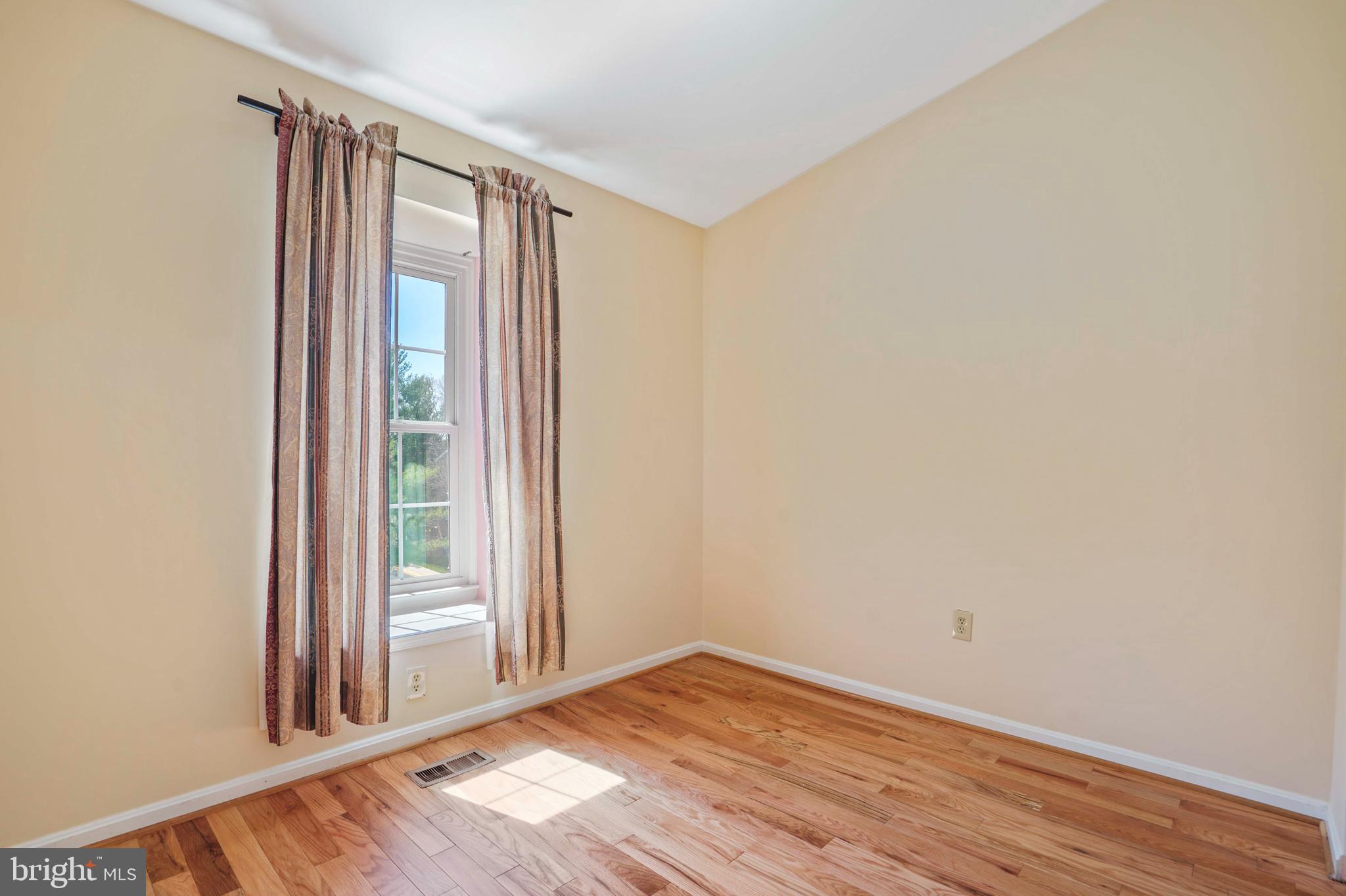 11322 Baritone Court Silver Spring, MD 20901 - Photo 17 of 29 an empty room with wooden floor and windows
