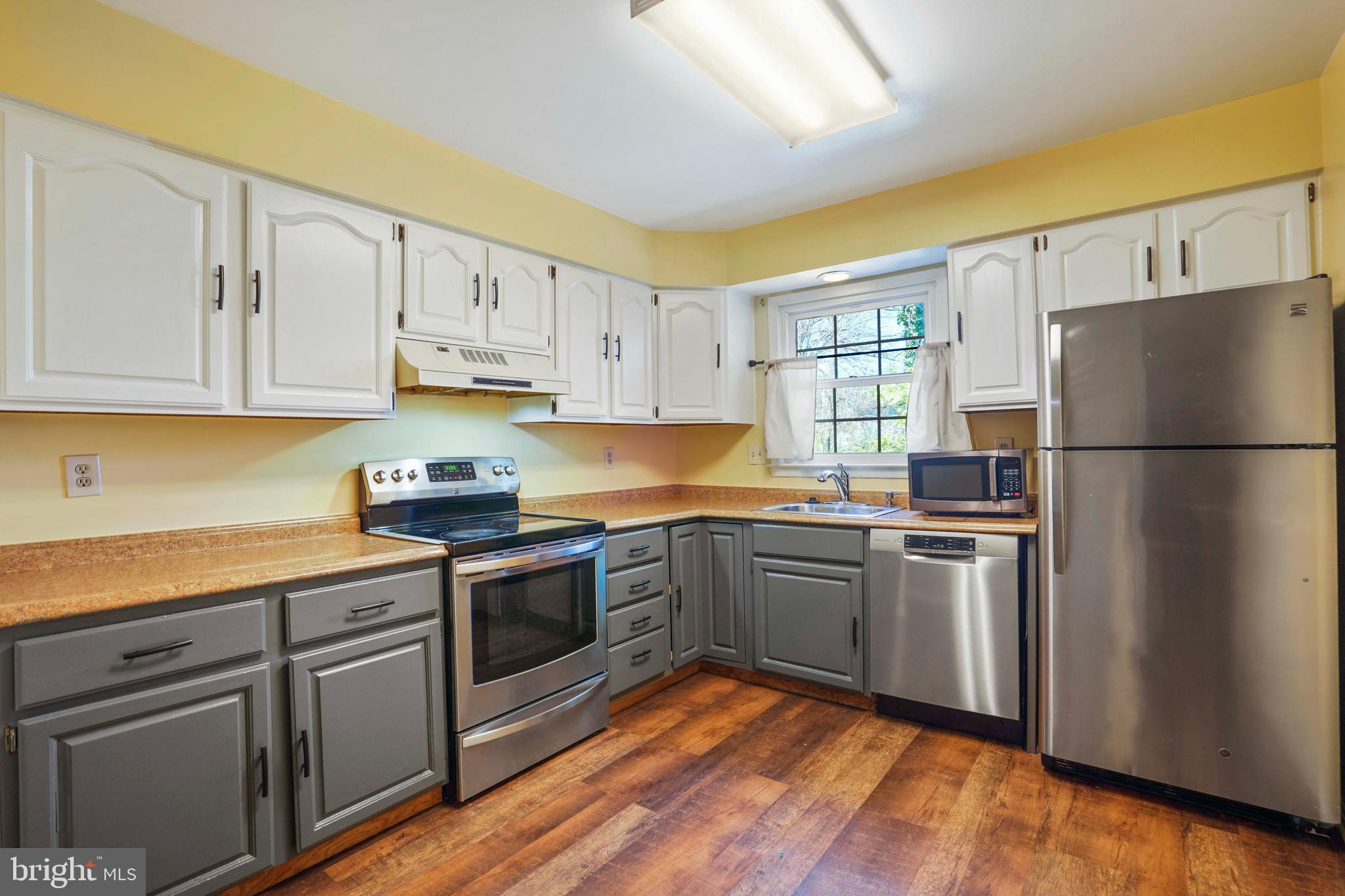 11322 Baritone Court Silver Spring, MD 20901 - Photo 2 of 29 a kitchen with cabinets appliances and wooden floor