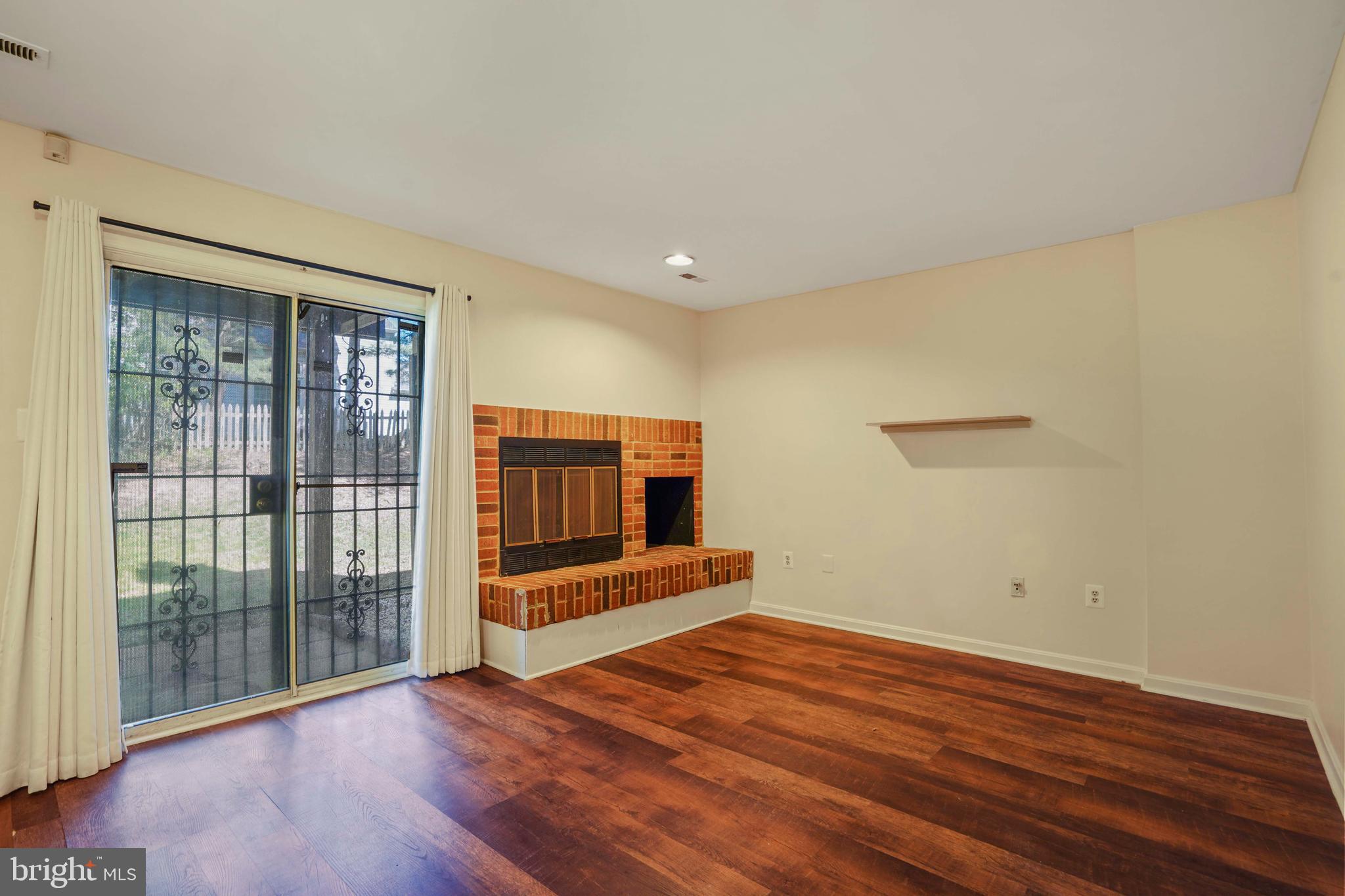 11322 Baritone Court Silver Spring, MD 20901 - Photo 22 of 29 wooden floor in an empty room with a window