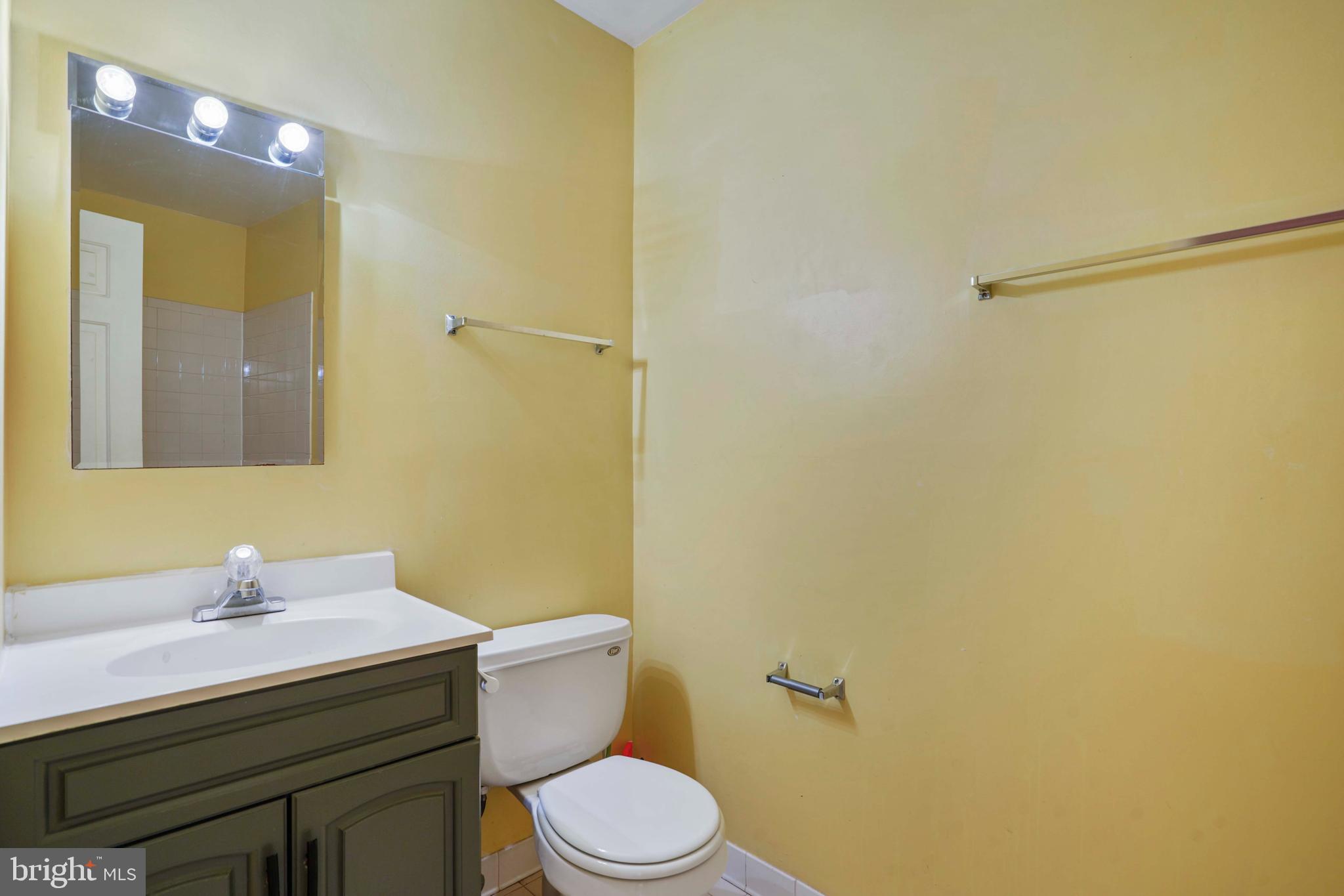 11322 Baritone Court Silver Spring, MD 20901 - Photo 26 of 29 a bathroom with a sink mirror vanity and toilet