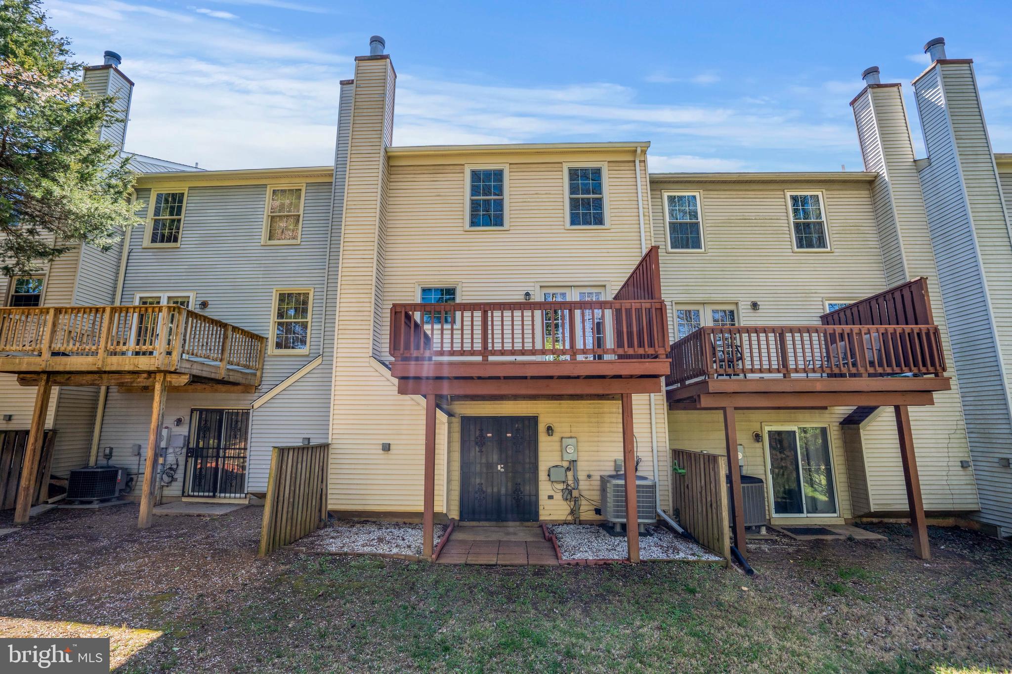 11322 Baritone Court Silver Spring, MD 20901 - Photo 29 of 29 a view of a house with a barbeque and large trees