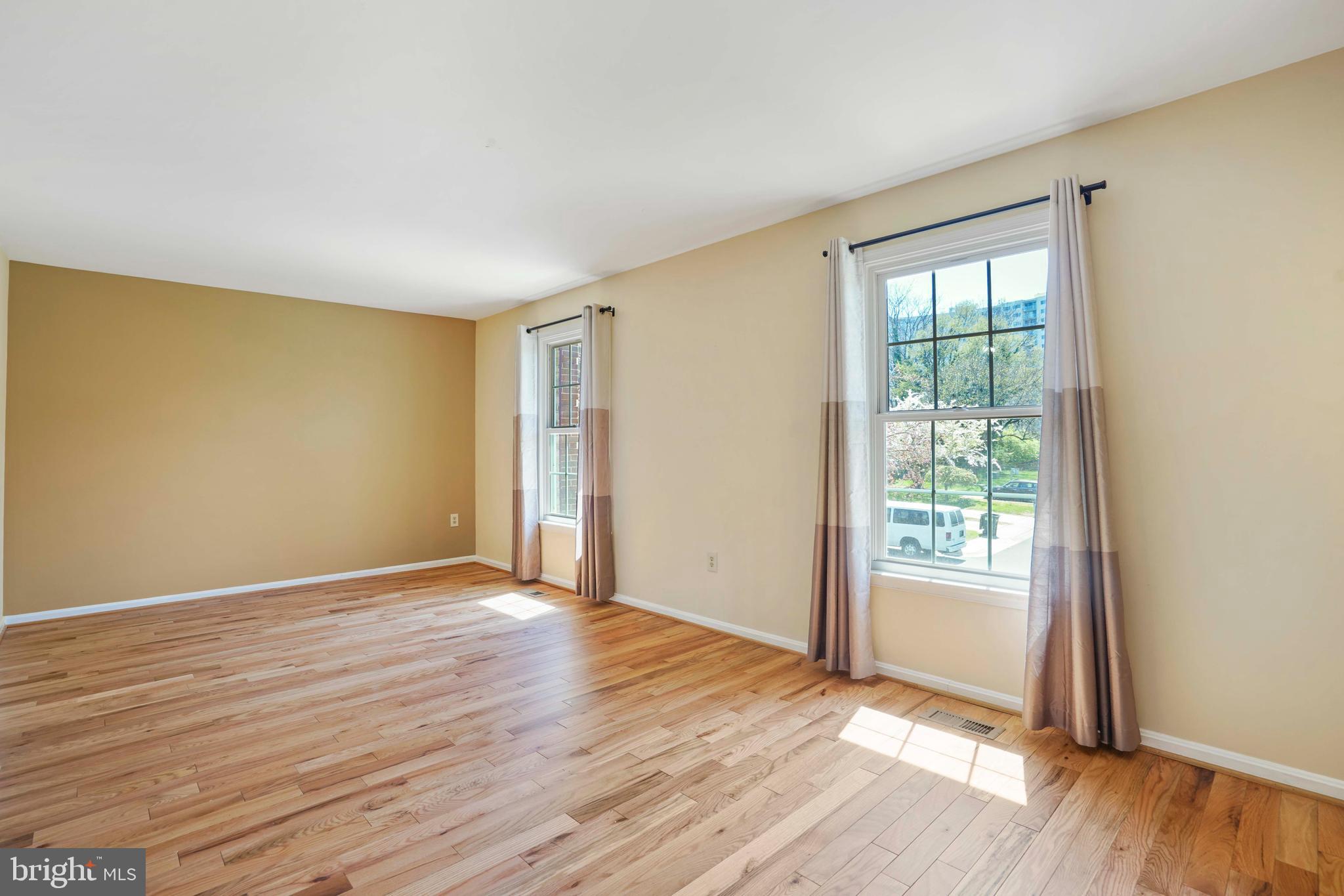 11322 Baritone Court Silver Spring, MD 20901 - Photo 4 of 29 an empty room with wooden floor and windows
