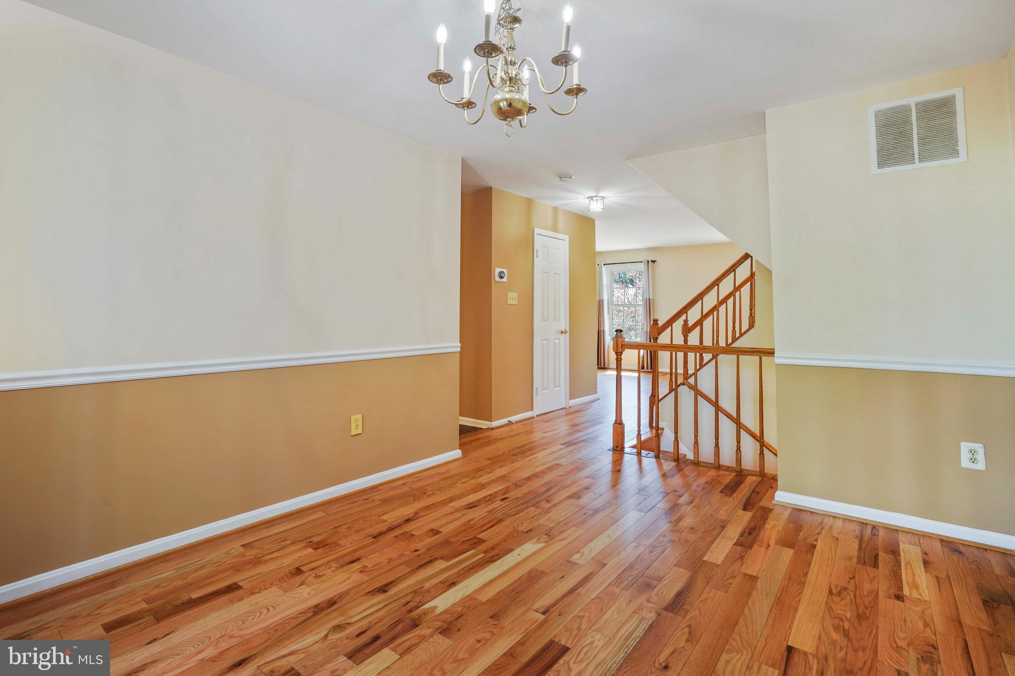 11322 Baritone Court Silver Spring, MD 20901 - Photo 6 of 29 a view of an empty room with wooden floor and a window