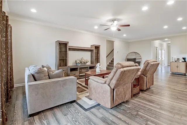 a living room with furniture and a wooden floor