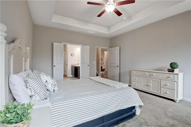 a bedroom with a large bed and a chandelier