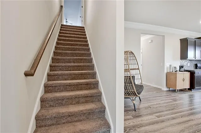 a view of entryway and hall with wooden floor