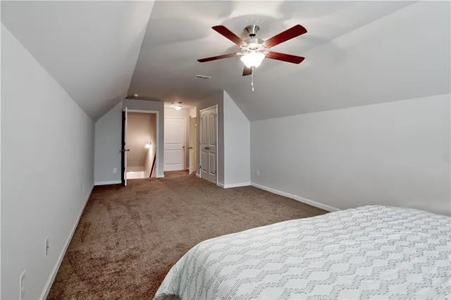 a bathroom with a granite countertop sink toilet a mirror and shower