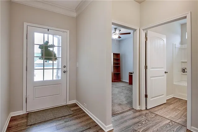an empty room and wooden door with glass door